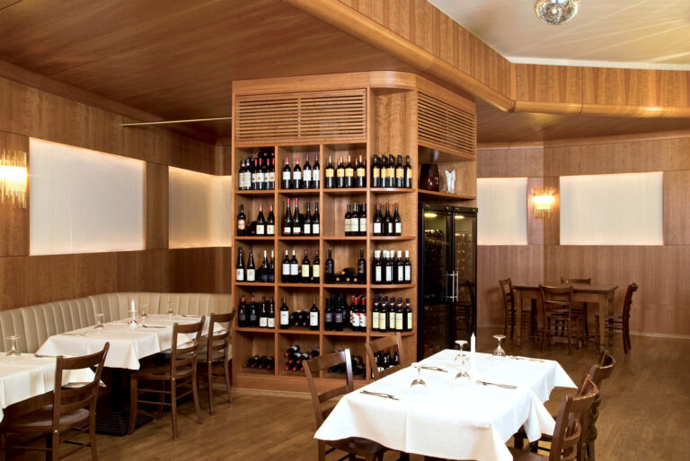 Ein Restaurant mit einer Holzwand und einem Weinregal aus Holz.